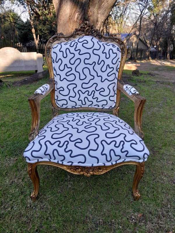 A 20th Century French Style Ornately Carved And Gilded Wooden Armchairs