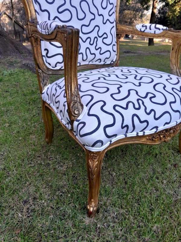 A 20th Century French Style Ornately Carved And Gilded Wooden Armchairs