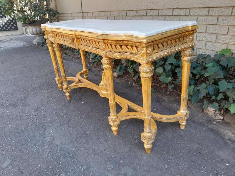 A 20th Century French Louis SVI Style Hand Gilded Console Table With Cream Marble Top