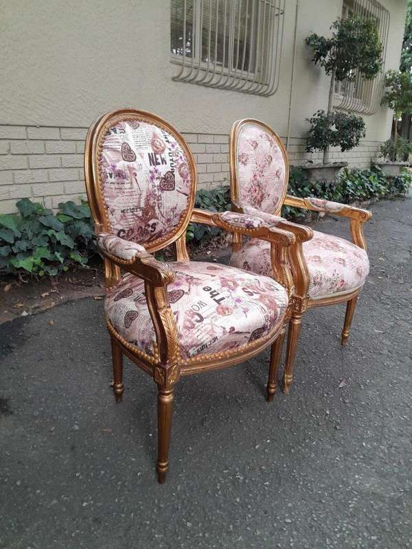 A 20th Century French Louis XVI Style Pair of Ornately Carved Gold Armchairs