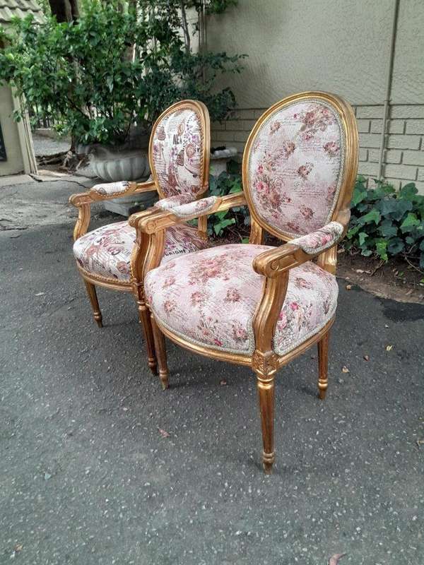 A 20th Century French Louis XVI Style Pair of Ornately Carved Gold Armchairs