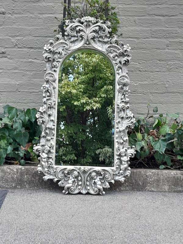 A 20th Century Ornately Carved, Bevelled and Gilt Mirror