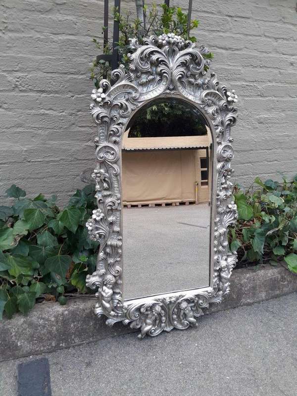 A 20th Century Ornately Carved, Bevelled and Gilt Mirror