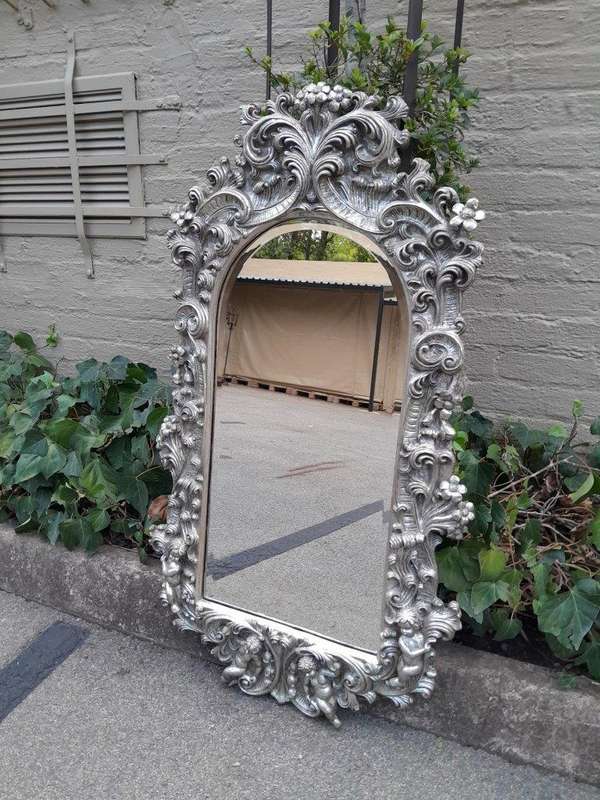 A 20th Century Ornately Carved, Bevelled and Gilt Mirror