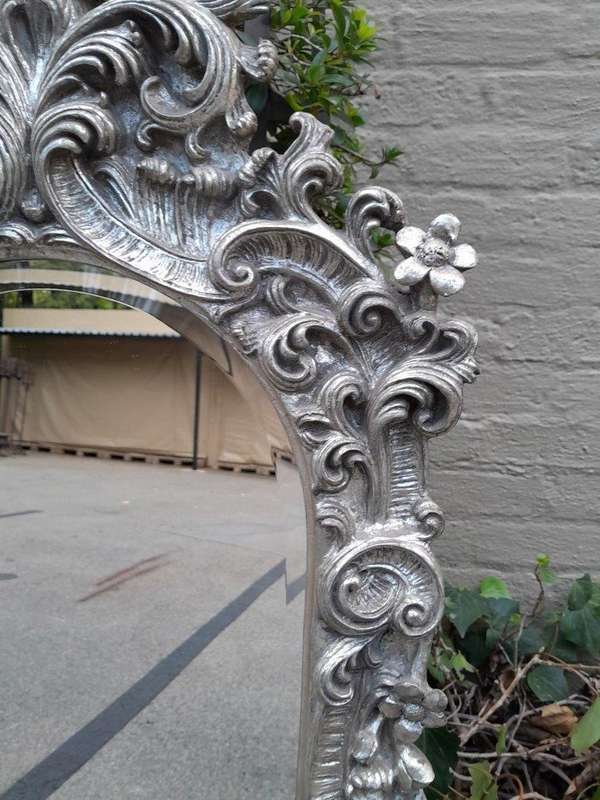 A 20th Century Ornately Carved, Bevelled and Gilt Mirror