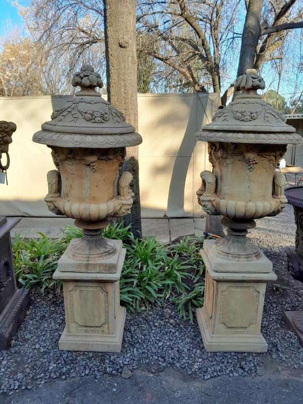 A 20th Century Pair of Large Decorative Concrete Urns with Lids on Plinths