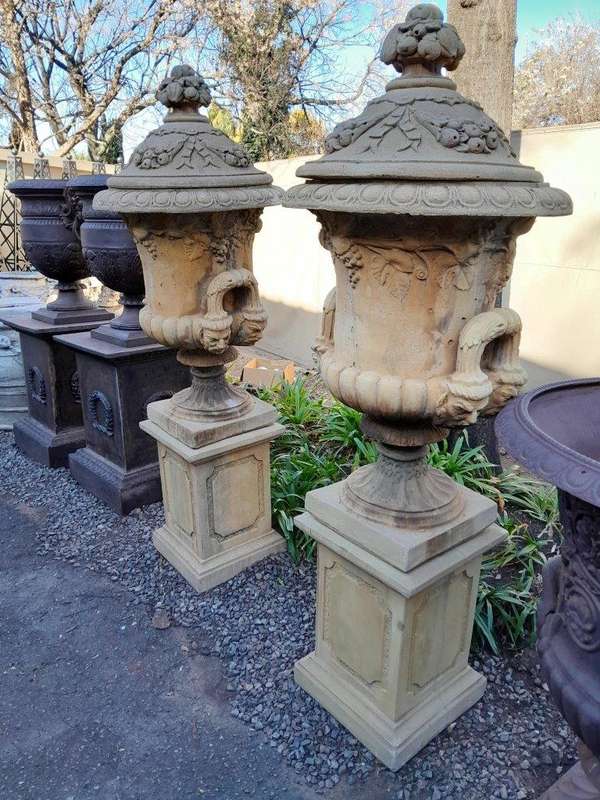 A 20th Century Pair of Large Decorative Concrete Urns with Lids on Plinths