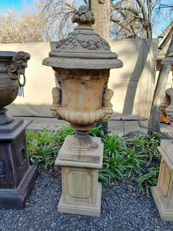 A 20th Century Pair of Large Decorative Concrete Urns with Lids on Plinths