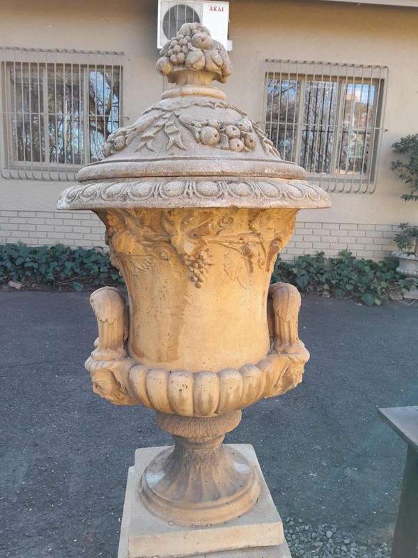 A 20th Century Pair of Large Decorative Concrete Urns with Lids on Plinths