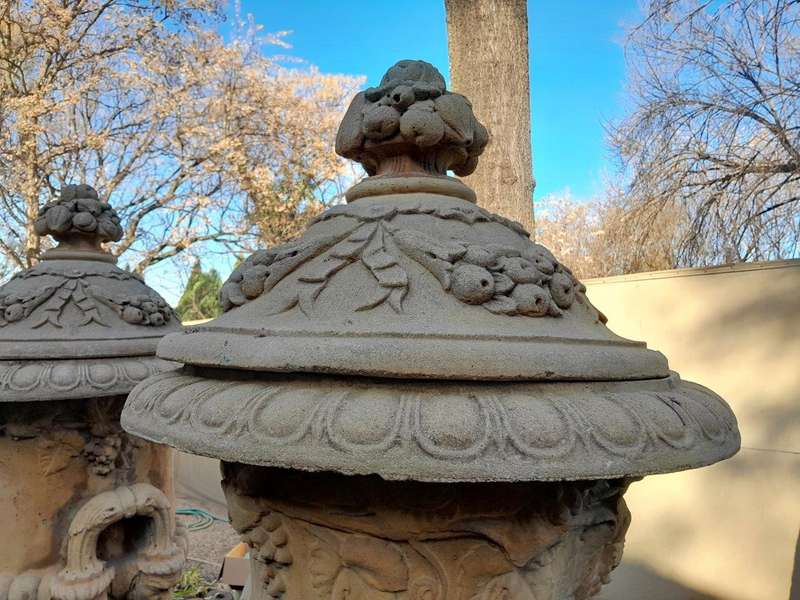 A 20th Century Pair of Large Decorative Concrete Urns with Lids on Plinths