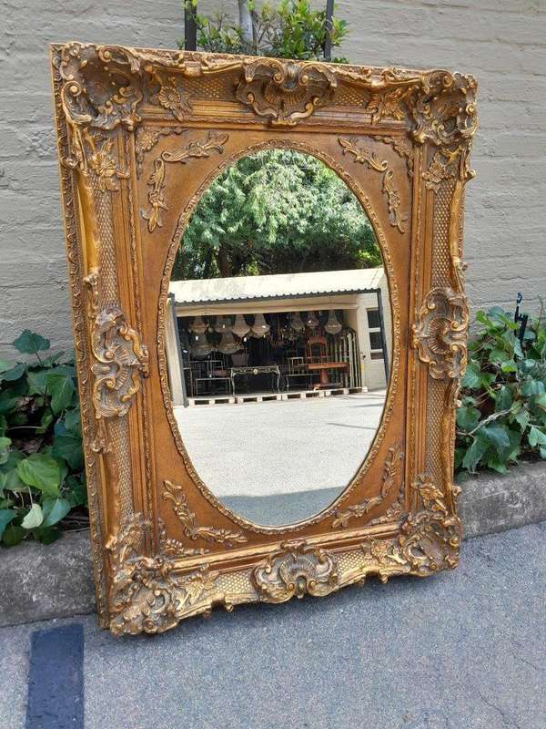 A 20th Century French Style Ornately Carved Bevelled and Gilt Wood Mirror