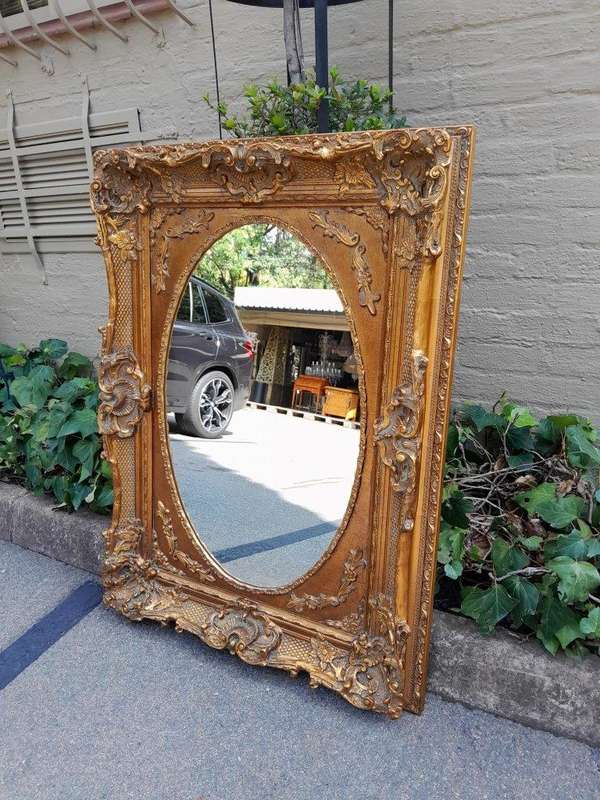 A 20th Century French Style Ornately Carved Bevelled and Gilt Wood Mirror