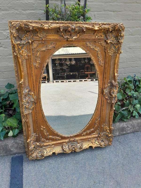 A 20th Century French Style Ornately Carved Bevelled and Gilt Wood Mirror