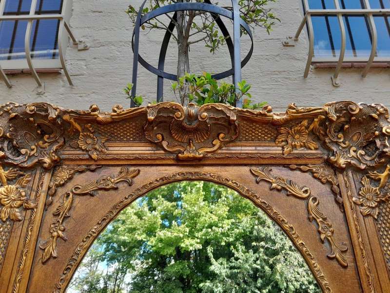 A 20th Century French Style Ornately Carved Bevelled and Gilt Wood Mirror