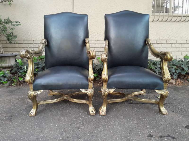 A 20th Century French Style Ornately Carved Pair Of Arm Chairs Hand Gilded And Upholstered In A D...