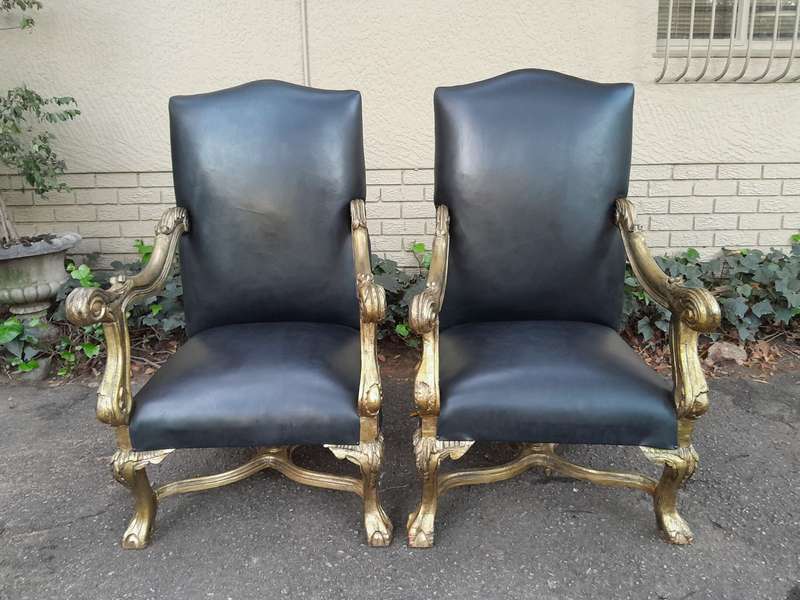 A 20th Century French Style Ornately Carved Pair Of Arm Chairs Hand Gilded And Upholstered In A D...