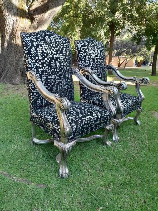 A 20th Century French Style Ornately Carved Pair Of Arm Chairs Hand Gilded And Upholstered In A D...