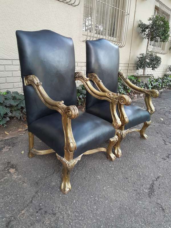 A 20th Century French Style Ornately Carved Pair Of Arm Chairs Hand Gilded And Upholstered In A D...