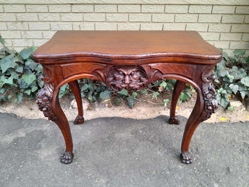 An Antique Jacobean Ornately Carved Oak Card Table with Black Baize