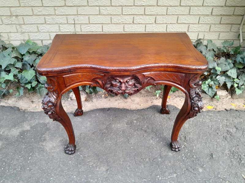 An Antique Jacobean Ornately Carved Oak Card Table with Black Baize