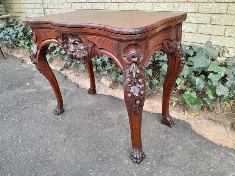 An Antique Jacobean Ornately Carved Oak Card Table with Black Baize