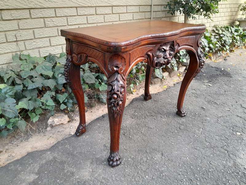 An Antique Jacobean Ornately Carved Oak Card Table with Black Baize