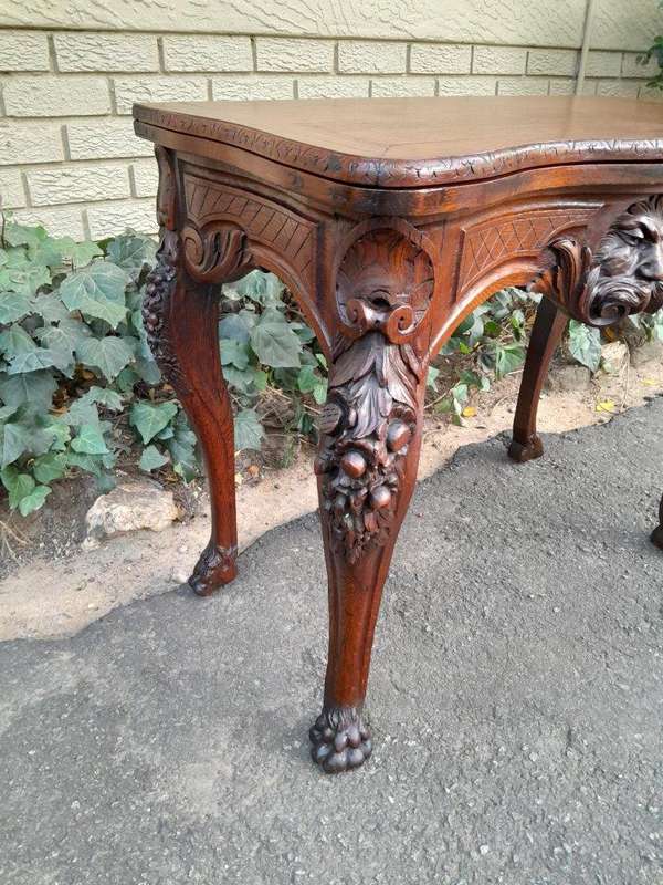 An Antique Jacobean Ornately Carved Oak Card Table with Black Baize