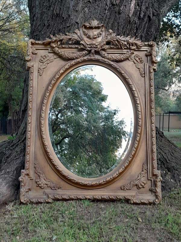 A French Rococo Style Ornately Carved and Gilded Bevelled Mirror