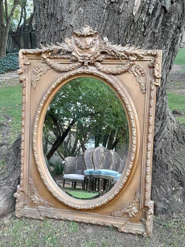 A French Rococo Style Ornately Carved and Gilded Bevelled Mirror