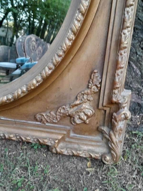 A French Rococo Style Ornately Carved and Gilded Bevelled Mirror
