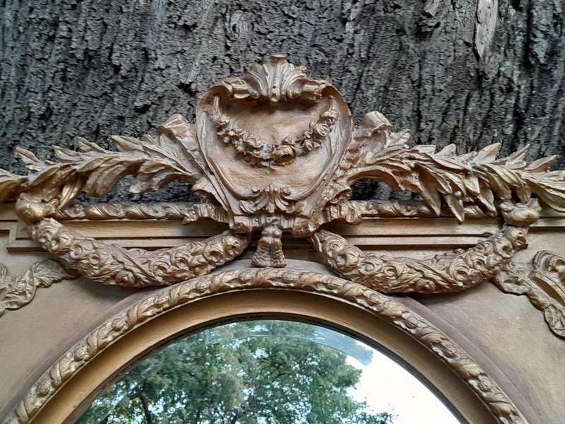 A French Rococo Style Ornately Carved and Gilded Bevelled Mirror