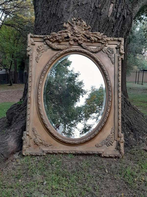 A French Rococo Style Ornately Carved and Gilded Bevelled Mirror