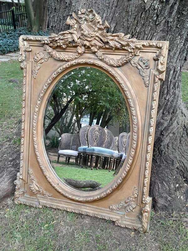 A French Rococo Style Ornately Carved and Gilded Bevelled Mirror