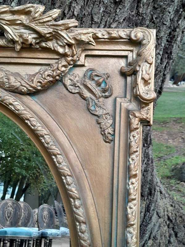 A French Rococo Style Ornately Carved and Gilded Bevelled Mirror