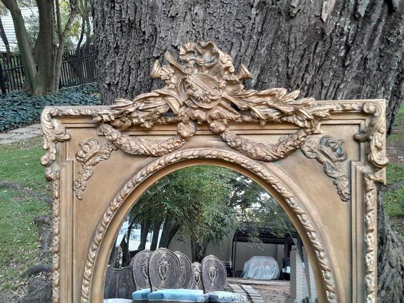 A French Rococo Style Ornately Carved and Gilded Bevelled Mirror