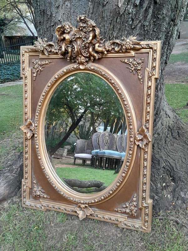 A French Rococo Style Ornately Carved and Gilded Bevelled Mirror