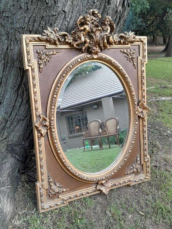 A French Rococo Style Ornately Carved and Gilded Bevelled Mirror