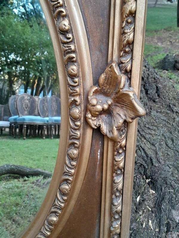 A French Rococo Style Ornately Carved and Gilded Bevelled Mirror