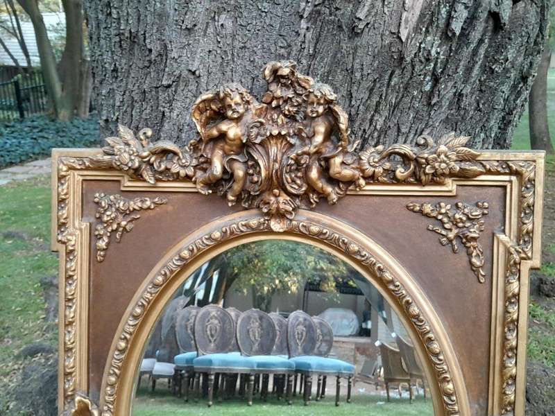 A French Rococo Style Ornately Carved and Gilded Bevelled Mirror