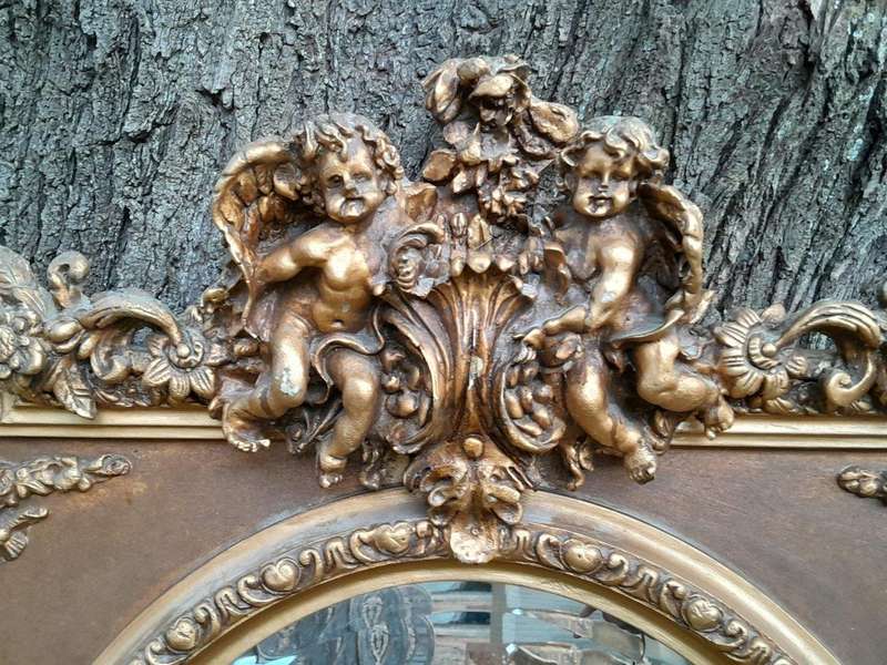 A French Rococo Style Ornately Carved and Gilded Bevelled Mirror