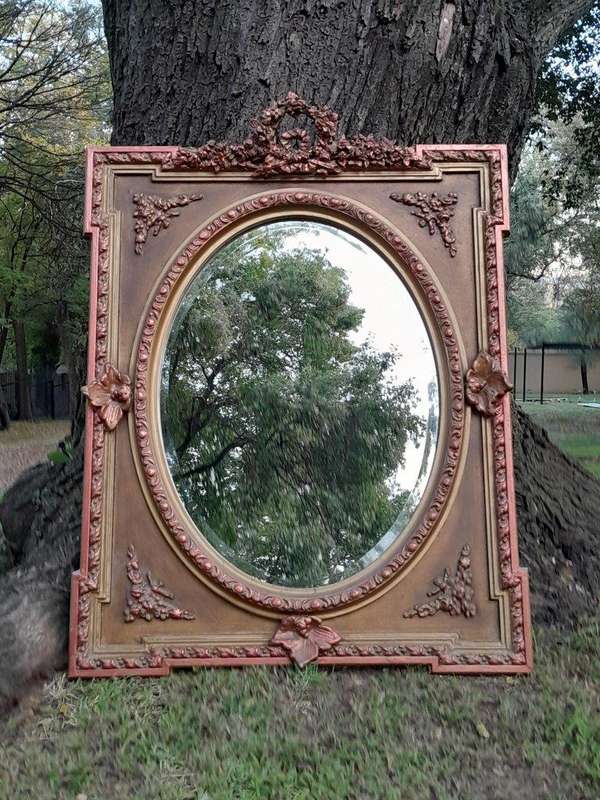 A French Rococo Style Ornately Carved and Gilded Bevelled Mirror