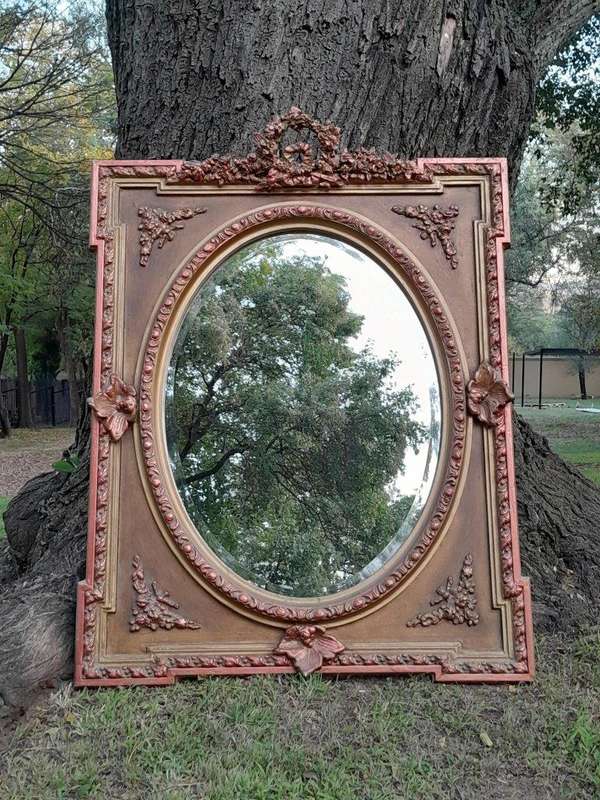 A French Rococo Style Ornately Carved and Gilded Bevelled Mirror