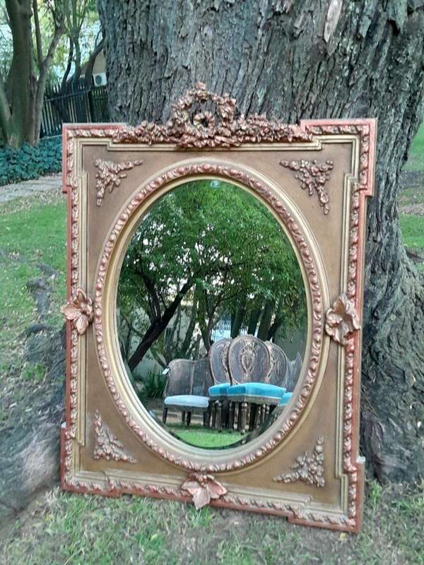 A French Rococo Style Ornately Carved and Gilded Bevelled Mirror