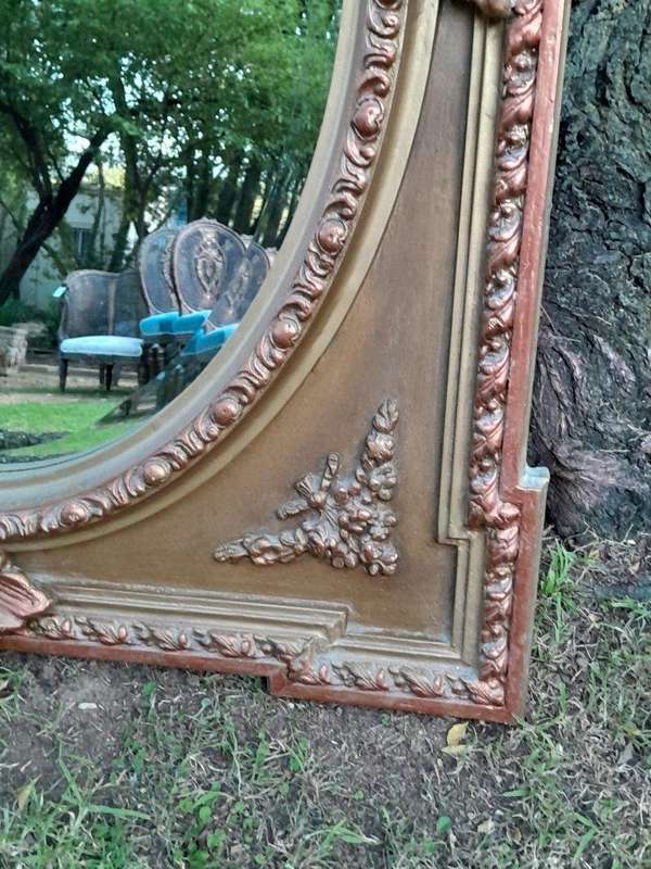 A French Rococo Style Ornately Carved and Gilded Bevelled Mirror