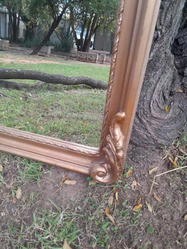 A French Rococo Style Ornately Carved and Gilded Bevelled Mirror