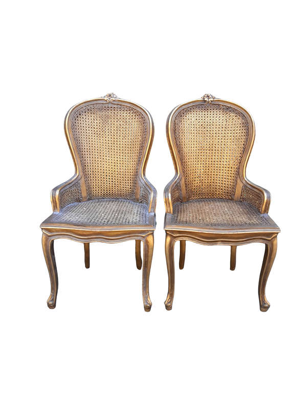A Pair of French Style Ornately Carved and Gilded Rattan High Back Armchairs