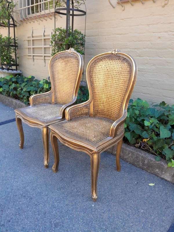 A Pair of French Style Ornately Carved and Gilded Rattan High Back Armchairs