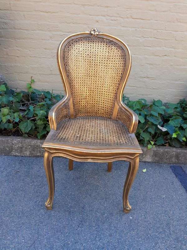 A Pair of French Style Ornately Carved and Gilded Rattan High Back Armchairs