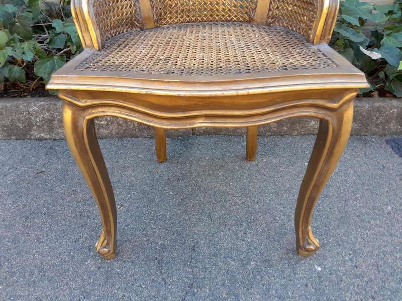 A Pair of French Style Ornately Carved and Gilded Rattan High Back Armchairs
