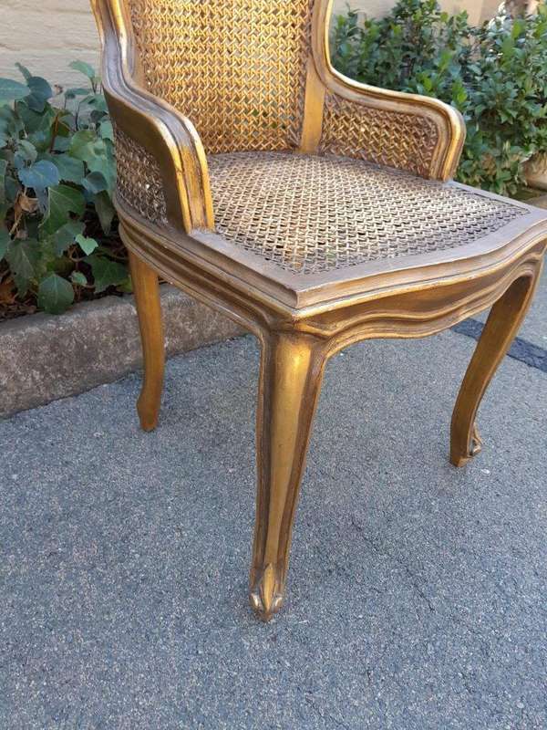 A Pair of French Style Ornately Carved and Gilded Rattan High Back Armchairs
